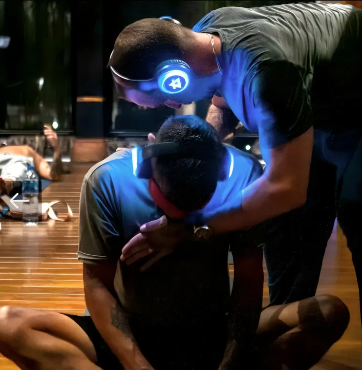A facilitator supporting a 9D Breathwork participant